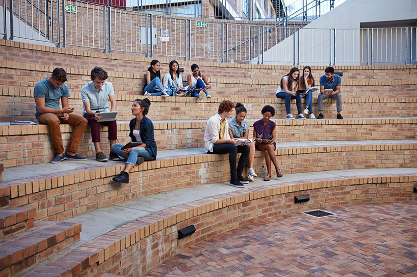 658984259 Students studying in groups outdoors on campus