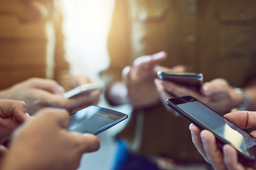 Group of people using smartphones in synchronicity.